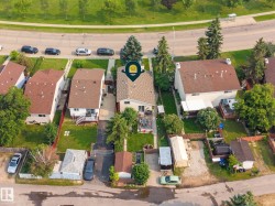 Aerial perspective showcasing a residential property with a light-colored exterior and a brown roof - 