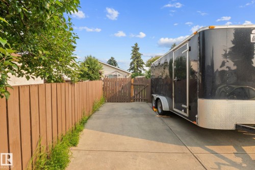 Paved side yard access featuring a wood privacy fence and a matching wood gate - 18126 98 Avenue, Edmonton, AB 