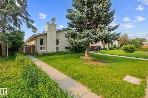 Side-split residence featuring beige siding and a prominent chimney - 18126 98 Avenue, Edmonton, AB 