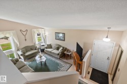 Foyer entry with a paneled door, overhead pendant lighting, and tiled flooring - 