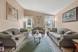 Living area featuring a vaulted ceiling and two large windows - 