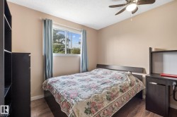 Room featuring wood-finish flooring, a contemporary ceiling fan, and a window with natural light - 