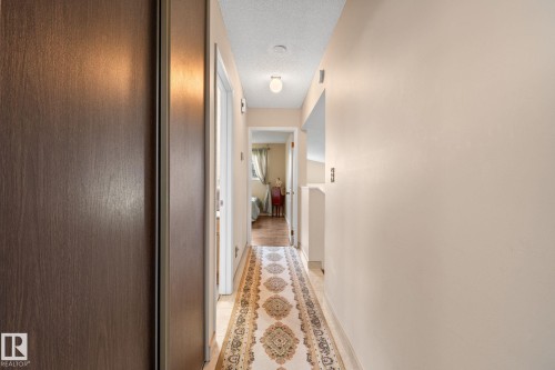 Hallway featuring wood-finish flooring, recessed lighting, and a neutral color palette - 18126 98 Avenue, Edmonton, AB 