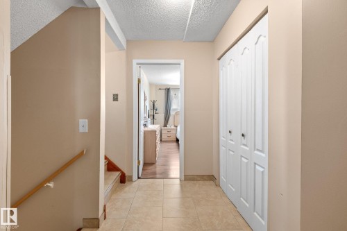 Hallway with neutral tone walls and large format tile flooring - 18126 98 Avenue, Edmonton, AB 