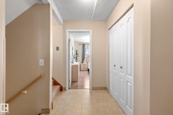 Hallway with neutral tone walls and large format tile flooring - 