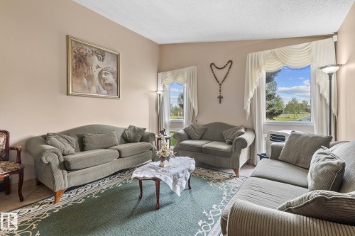 Bright living area featuring twin windows, neutral wall tones, and a light-colored ceiling - 18126 98 Avenue, Edmonton, AB 