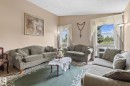 Bright living area featuring twin windows, neutral wall tones, and a light-colored ceiling - 18126 98 Avenue, Edmonton, AB 