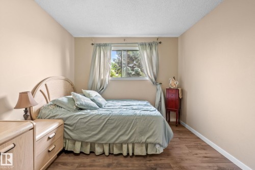 Bedroom featuring wood-finish flooring and a single window with curtain rods - 18126 98 Avenue, Edmonton, AB 