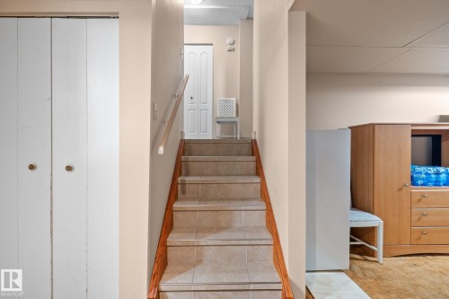Tiled staircase featuring wood-finish handrail - 18126 98 Avenue, Edmonton, AB 