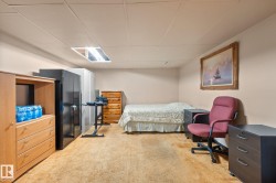Carpeted room with a drop ceiling featuring recessed lighting - 