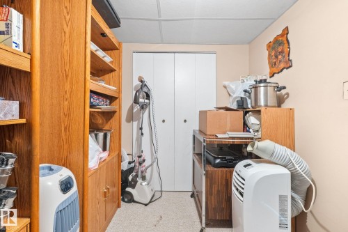Built-in wood-finish shelving with cabinet storage and a drop ceiling - 18126 98 Avenue, Edmonton, AB 
