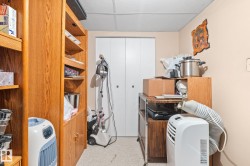 Built-in wood-finish shelving with cabinet storage and a drop ceiling - 