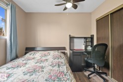 Interior room featuring wood-finish flooring, a window with natural light, and a ceiling fan - 