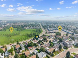 Aerial perspective showcasing a residential neighborhood with a prominent green space - 