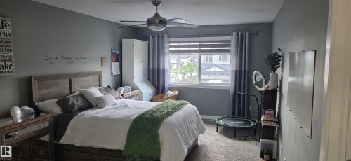 Spacious room featuring neutral grey walls and a large window with blinds - 16505 133 Street, Edmonton, AB 