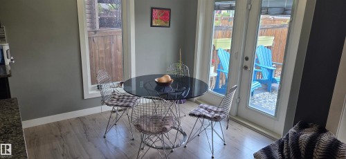 Dining area featuring light wood-finish flooring and a neutral color palette - 16505 133 Street, Edmonton, AB 