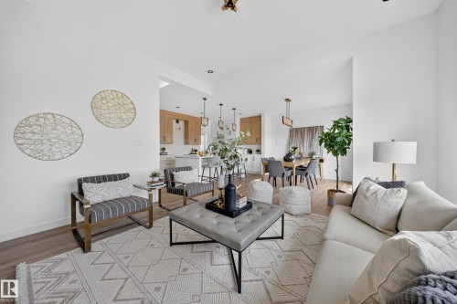 Open concept living area featuring wood-finish flooring - 523 Ashgrove Circle, Leduc, AB 