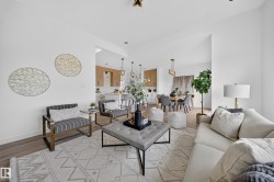 Open concept living area featuring wood-finish flooring - 