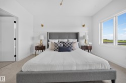Carpeted bedroom with a large window and white trim - 