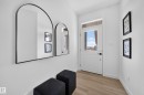 Entryway featuring wood-finish flooring, white walls, and a door with a clear glass insert and transom window - 523 Ashgrove Circle, Leduc, AB 