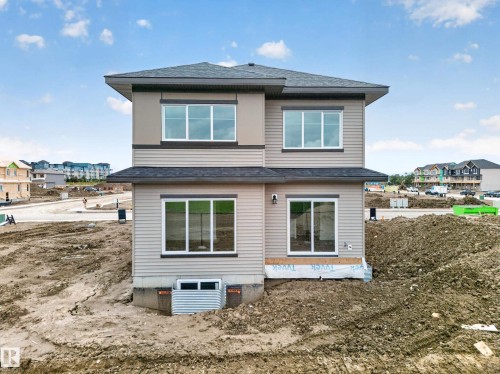 Contemporary two-story exterior with horizontal siding and upper-level accent panels - 523 Ashgrove Circle, Leduc, AB 
