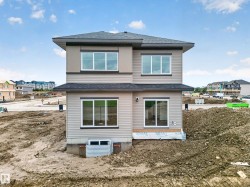 Contemporary two-story exterior with horizontal siding and upper-level accent panels - 