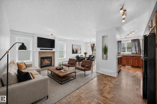 Virtually staged - 67 Hartwick Loop, Spruce Grove, AB - Indoor Photo Showing Living Room With Fireplace