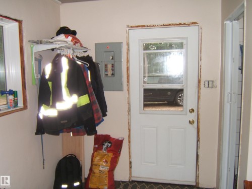 Entry door with upper window pane and brass-toned hardware - 163062 Twp Rd 565, Rural Lamont County, AB 