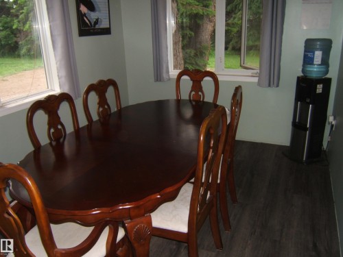 Dining area featuring wood-finish flooring and light green walls - 163062 Twp Rd 565, Rural Lamont County, AB 