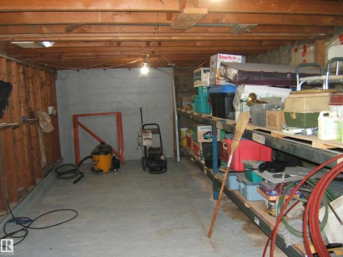 Unfinished basement offering exposed wood ceiling joists, concrete flooring, and bare wood wall framing - 163062 Twp Rd 565, Rural Lamont County, AB 