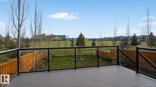 Spacious exterior deck with composite decking and contemporary glass panel railing - 104 Edgewater Circle, Leduc, AB 