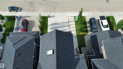 New construction properties featuring dark shingle roofs - 