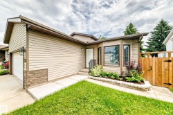 Exterior featuring beige horizontal siding with stone veneer accents - 