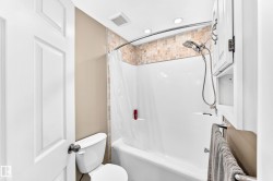 Bathroom featuring a full tub with shower, mosaic tile surround, recessed lighting, and an overhead ventilation fan - 