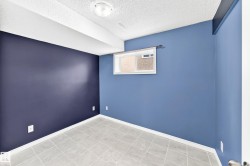 Room featuring light gray square floor tiles and contrasting blue wall tones - 
