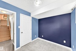 Room featuring a full wall in a deep blue tone, complemented by lighter blue walls and a white ceiling - 