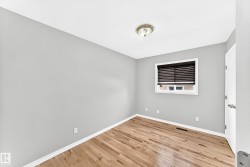 Hardwood flooring complemented by light gray walls and white trim - 