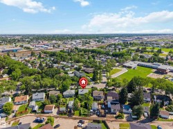 Aerial perspective showcasing a residential neighborhood with established homes and mature trees - 