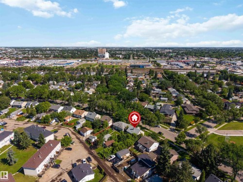 Aerial perspective showcasing an established neighborhood with a mix of residential structures and abundant mature trees - 12943 Sherbrooke Avenue, Edmonton, AB 