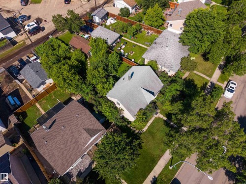 Aerial perspective showcasing the property's roofline, surrounding mature trees, and defined property lines - 12943 Sherbrooke Avenue, Edmonton, AB 