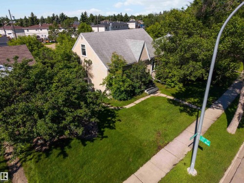 Cream-colored stucco exterior with a gray shingle roof - 12943 Sherbrooke Avenue, Edmonton, AB 