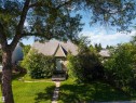Gabled home exterior featuring a light-colored entry door, stone steps, and a shingled roof - 12943 Sherbrooke Avenue, Edmonton, AB 