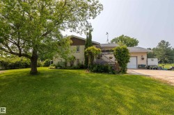 Spacious exterior featuring a stucco facade, attached garage with white door, and an upper-level deck - 