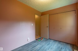 Room featuring wood-finish flooring, a neutral wall color, and a textured ceiling - 