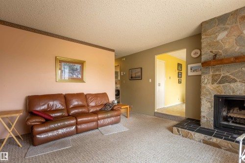 Stone-clad fireplace with a wood mantel - 59228 Rg Rd 11, Rural Westlock County, AB 