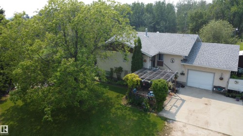 Residence featuring a light-colored exterior and a gray shingle roof - 59228 Rg Rd 11, Rural Westlock County, AB 
