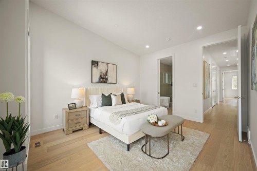 Spacious bedroom featuring light wood-finish flooring, recessed lighting, and a vaulted ceiling - 14037 104 Avenue, Edmonton, AB - Indoor Photo Showing Bedroom