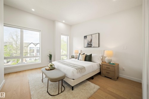 Bright room featuring light wood-finish flooring, recessed lighting, and large windows - 14037 104 Avenue, Edmonton, AB - Indoor Photo Showing Bedroom