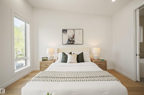 Room featuring wood-finish flooring, a contemporary window, recessed ceiling lighting, and a white paneled door - 14037 104 Avenue, Edmonton, AB - Indoor Photo Showing Bedroom