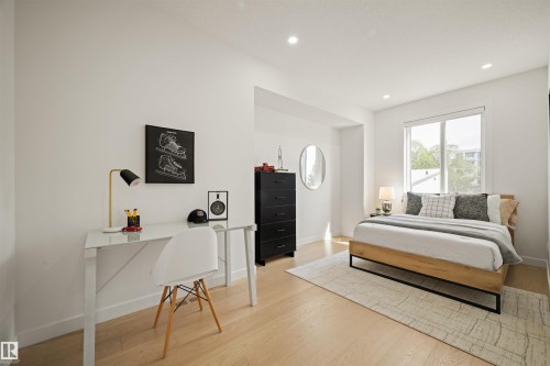 Room featuring light wood-finish flooring, recessed lighting, and a broad window - 14037 104 Avenue, Edmonton, AB - Indoor Photo Showing Bedroom